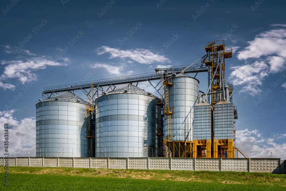 Modern Granary elevator. Silver silos on agro-processing and manufacturing plant for processing drying cleaning and storage of agricultural products, flour, cereals and grain. seed cleaning line Modern Granary elevator. Silver silos on agro-processing and manufacturing plant for processing drying cleaning and storage of agricultural products, flour, cereals and grain. seed cleaning line