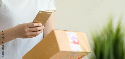 Asian business owner working at home with packing box of her online store prepare to deliver products to customers,sme,start up small business concept.