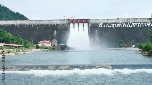 Floodgate with flowing water through gate slow motion, Open the springway.( Thai text Khun Dan Prakan Chon Dam )  Thailand photo