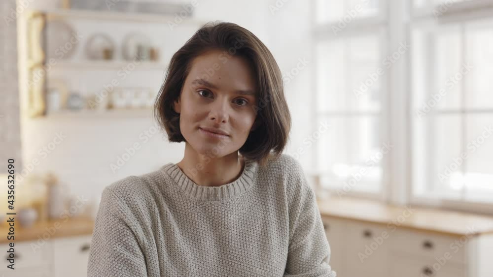 Pleasant lady in domestic outfit standing on bright kitchen Pleasant lady in domestic outfit standing on bright kitchen