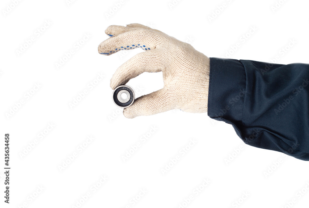 Fototapeta premium An auto mechanic holds in his hand a faulty timing belt idler on a white background, isolate. Close-up, inspection