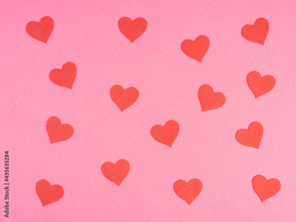 Pattern from red hearts on a pink background