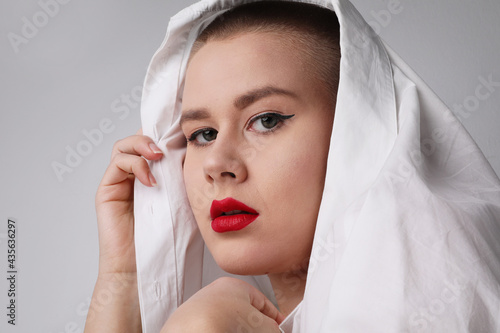 Close-up of beautiful young bald woman, posing in the studio. Isolated. photo