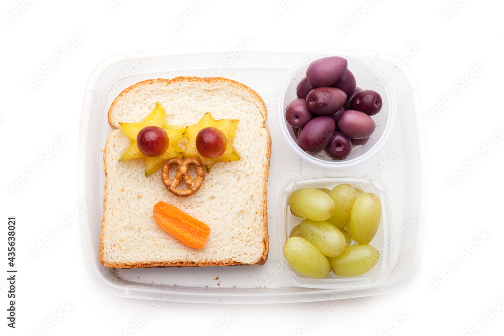 School lunch box snacks for kids over white background. Back to school. Healthy and fun snacks option for parents. Cute food art creative concepts. Bows with fruits and vegetables and cute sandwich. School lunch box snacks for kids over white background. Back to school. Healthy and fun snacks option for parents. Cute food art creative concepts. Bows with fruits and vegetables and cute sandwich.