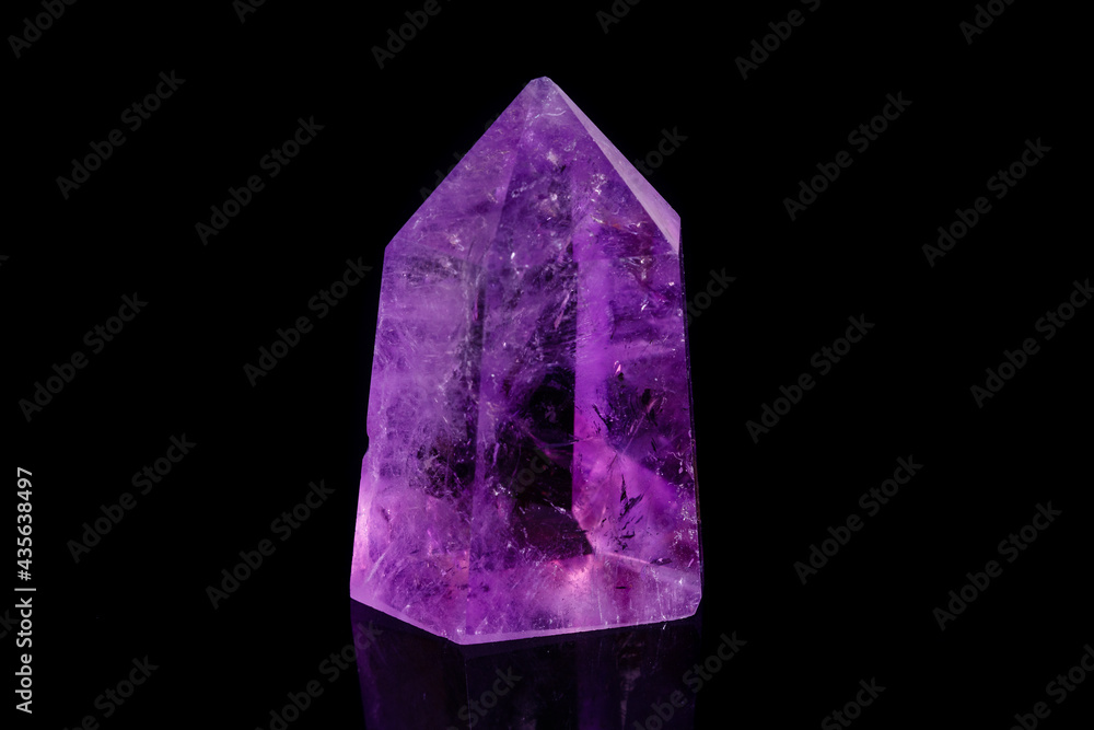 Macro mineral stone Amethyst crystal on a black background Macro mineral stone Amethyst crystal on a black background