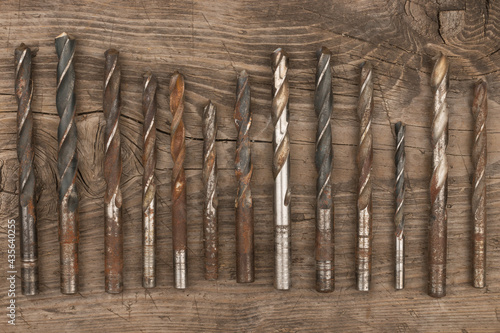 Old drills lying on an old wooden board. Copy space. photo