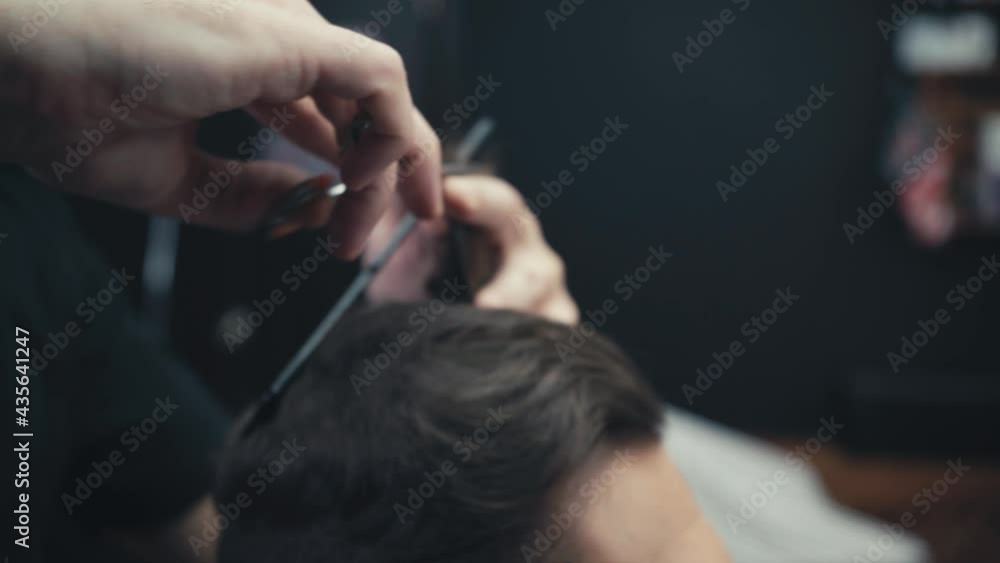 Close up view of barber cutting hair of man Close up view of barber cutting hair of man
