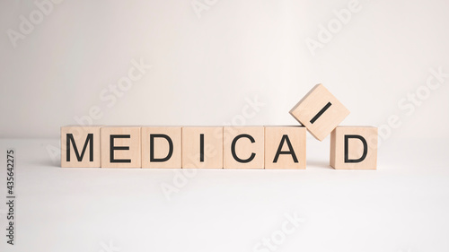 The word medicaid is written on wooden cubes on a light background. Business concept photo