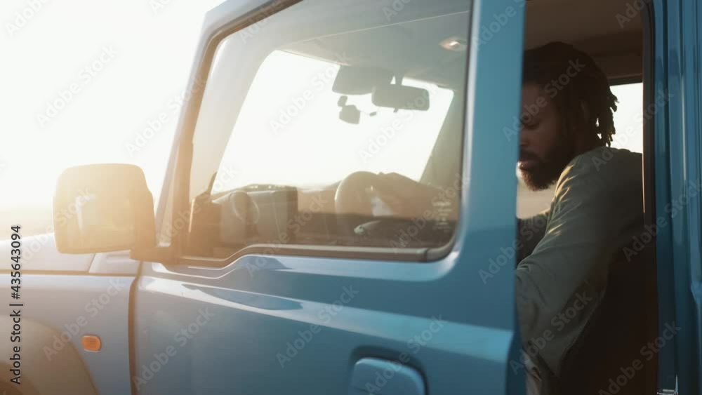The African man getting out of the car in the nature