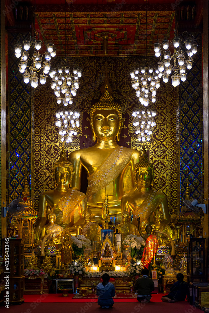 Three golden Buddha statues in lamphun, Thailand