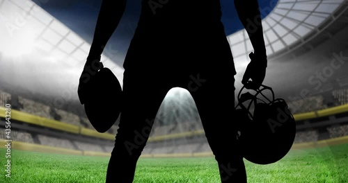 Animation of silhouette of american football player over sports stadium photo