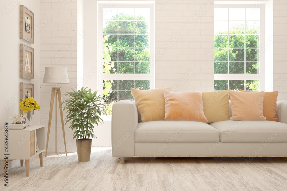 Fototapeta premium White living room with sofa and summer landscape in window. Scandinavian interior design. 3D illustration