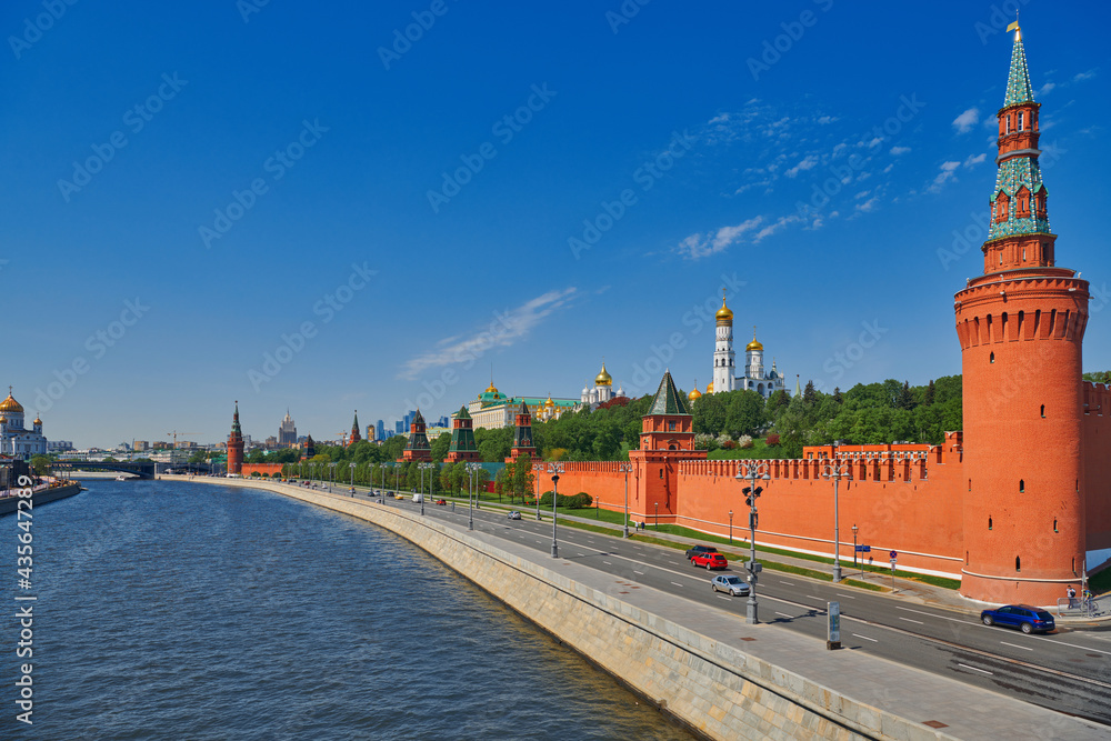 View of the Moscow Kremlin from the Moscow river. Red brick towers and Bell Tower Of Ivan The Great. Grand Kremlin palace. Travel to the capital of Russia. Moscow, Russia.