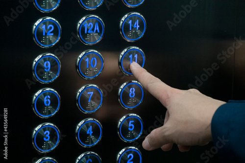 Hand push the elevator button 11th floor