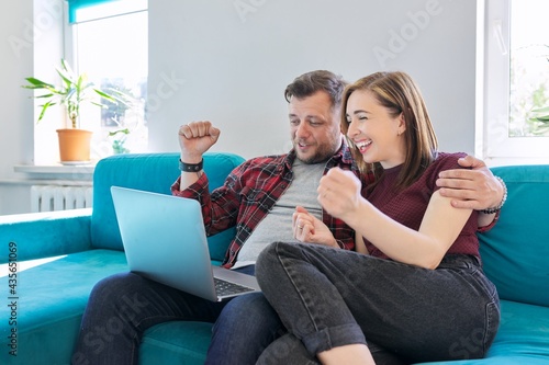 Luck, happiness, joy, victory, won, happy emotional middle aged couple looking in laptop