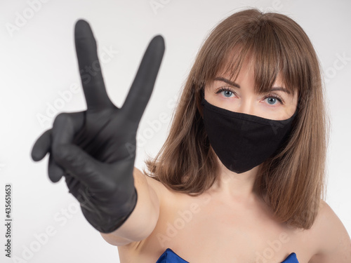 Woman in medical mask shows...
