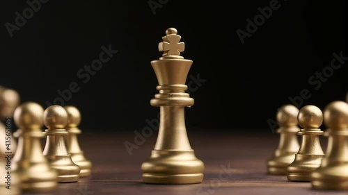 The concept of a successful boss and leader in the form of chess pieces.