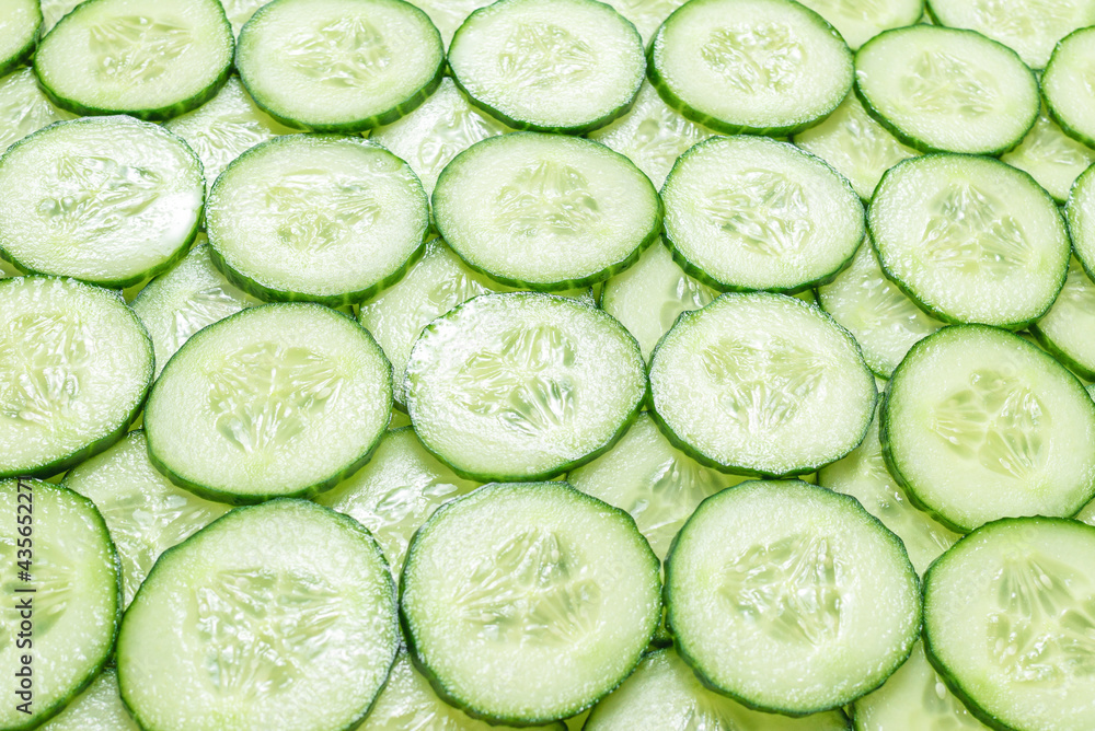 Fresh green slices of cucumber as background. Fresh green slices of cucumber as background.
