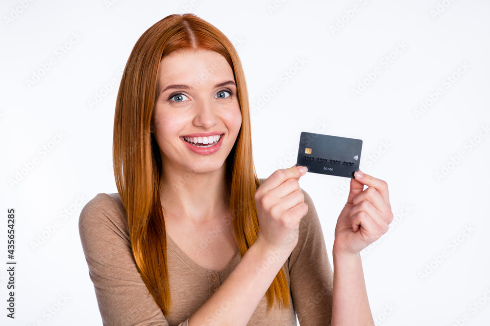 Photo of pretty sweet redhair woman beige shirt holding arms bank card smiling isolated white color background Photo of pretty sweet redhair woman beige shirt holding arms bank card smiling isolated white color background