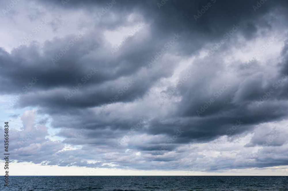 Dark dramatic sky and stormy clouds over the sea