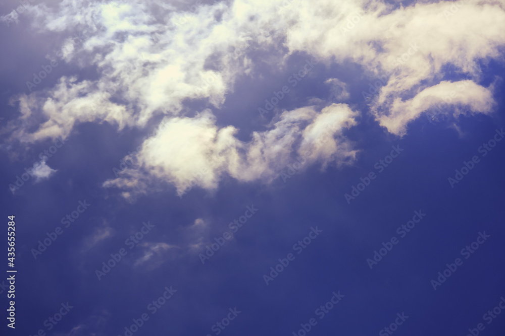 Fototapeta premium Thunderous black cloud on a dark sky background with sun rays