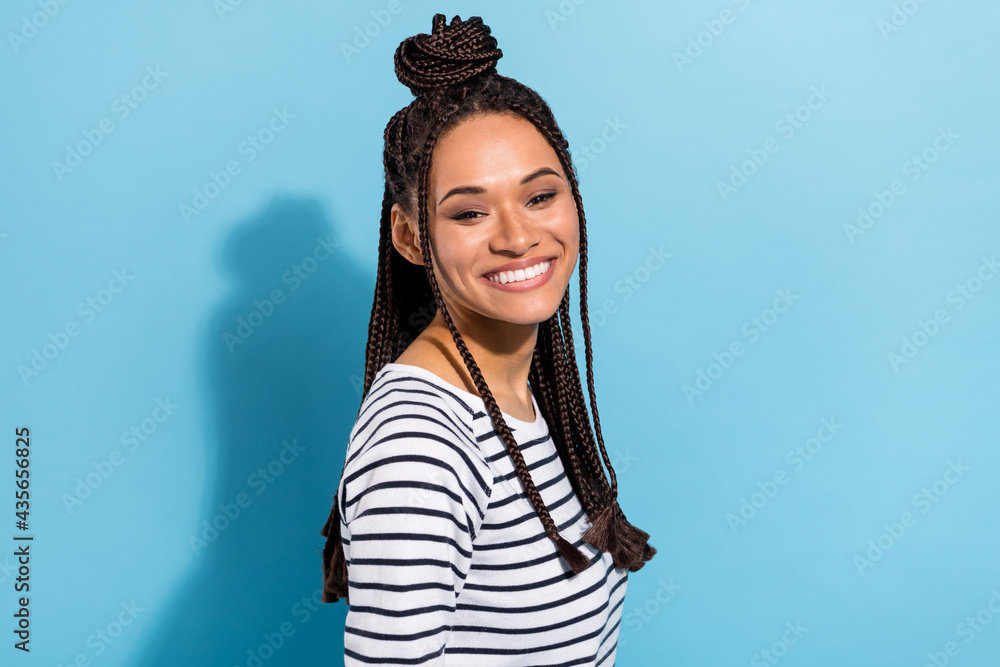 Side profile photo portrait of girl with dreadlocks cheerful smiling toothy isolated pastel blue color background Side profile photo portrait of girl with dreadlocks cheerful smiling toothy isolated pastel blue color background