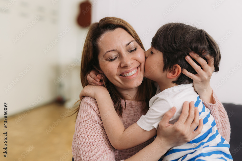 mother and her child kissing and hugging mother and her child kissing and hugging