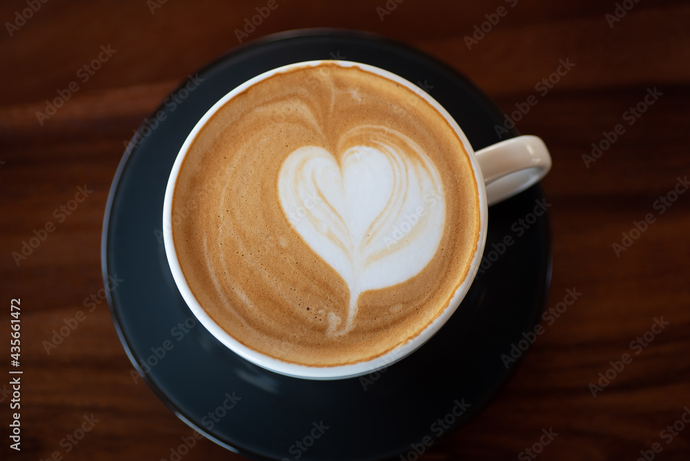 Cup of hot latte art coffee on wooden table Cup of hot latte art coffee on wooden table