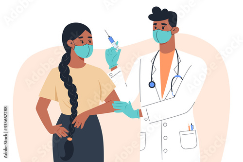 A male doctor in a mask and gloves makes a vaccine to a female patient