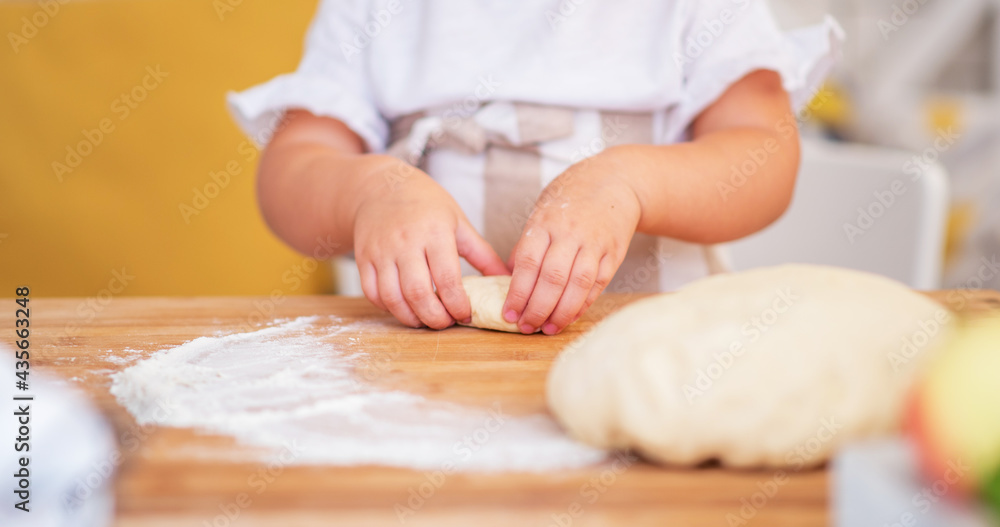Children's hand making cookies. Little cute girl in preparing cookies for christmas. Children's hand making cookies. Little cute girl in preparing cookies for christmas.