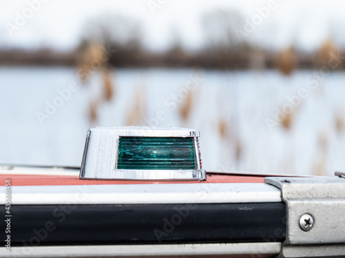 Valokuva Close up view of the green (starboard) side running lights on an old motor boat