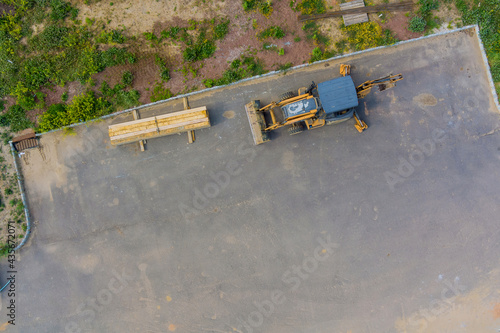 Aerial view of forklift stacker wooden boards on beams house on of new home construction