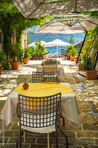 BUDVA, MONTENEGRO - 9 AUGUST, 2019: Restaurant with flowers in the old town of Budva, Montenegro photo