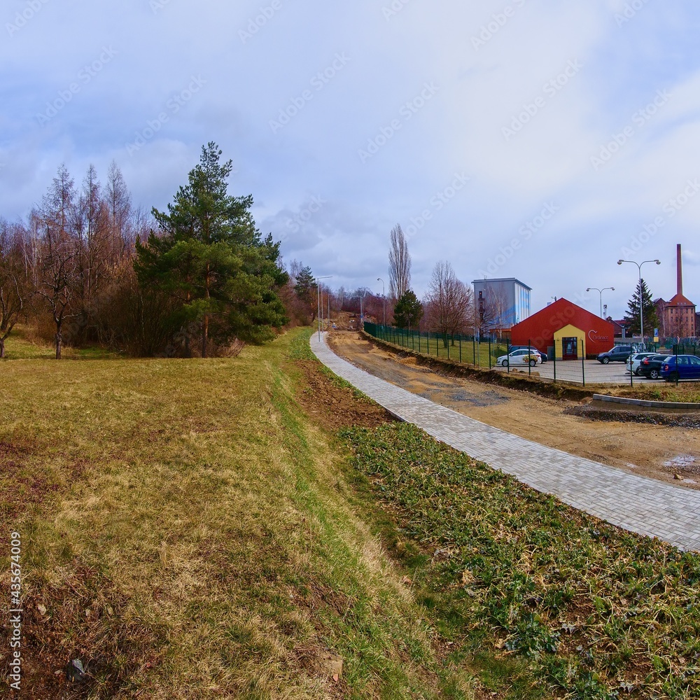 Fototapeta premium Chomutov, Czech republic - March 15, 2021: sunny spring street during reconstruction