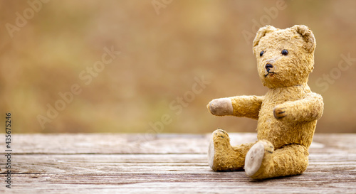 Positive emotion, feeling, hope concept, retro toy bear giving paws. Web banner.