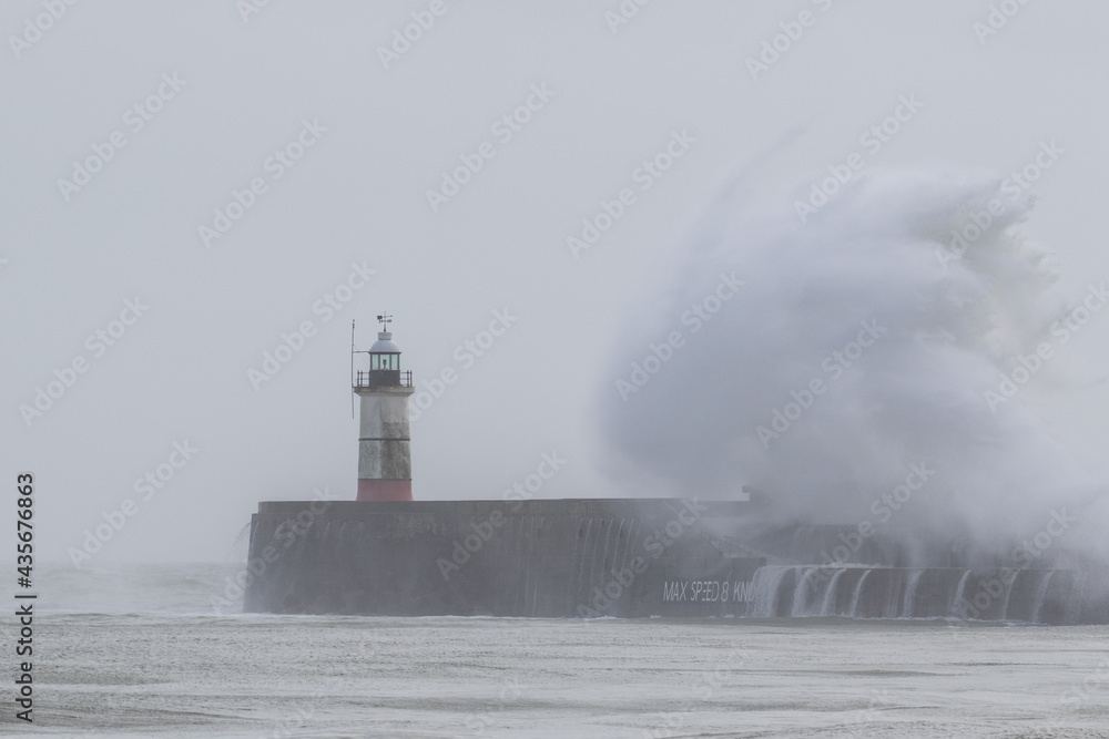 Waves pound Newhaven harbour entrance.