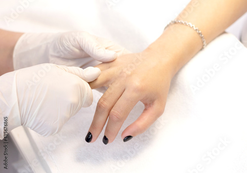 Massage of women's hands with a beauty salon specialist after a manicure procedure. Close-up. The concept of professional hand and nail care.