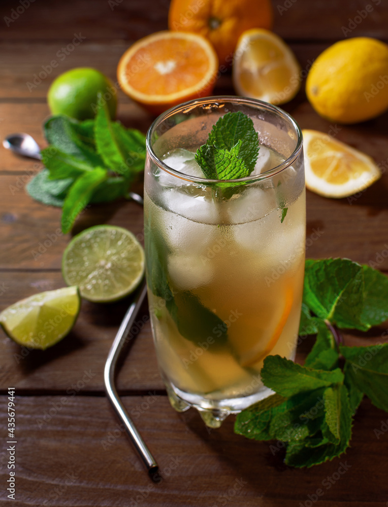 a cold refreshing drink in a glass cup. A cold drink in a glass with ice. Citrus drink on the rocks. a cold refreshing drink in a glass cup. A cold drink in a glass with ice. Citrus drink on the rocks.