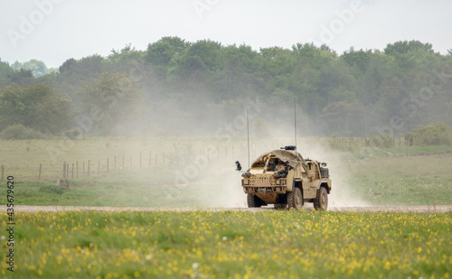 British army Supacat Jackal MWMIK rapid assault, fire support and reconnaissance vehicle on maneuvers in a demonstration of firepower, Salisbury Plain military training area UK photo