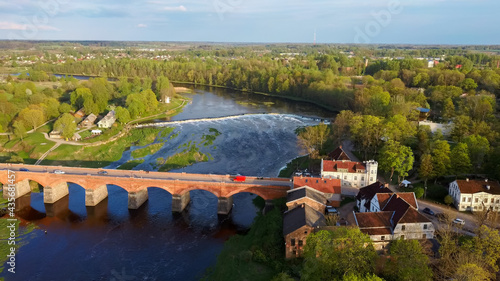 Long Old Brick Bridge, Kuldiga, Latvia Across the Venta River. Captured From Above. The Widest Waterfall in Europe in Background