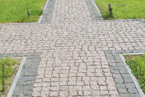 Photo Granite pavement. Footpaths with granite cobblestones