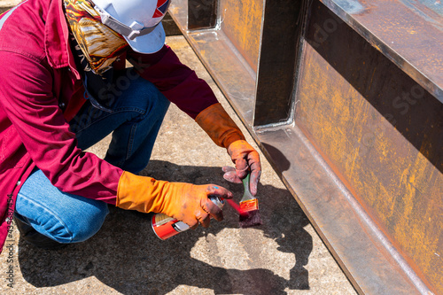 The step two of doing penetrant testing is step to use spray Liquid Penetrant into the brush before apply to the welded for Non-Destructive Testing(NDT) with process Penetrant Testing(PT). © Thaweesak