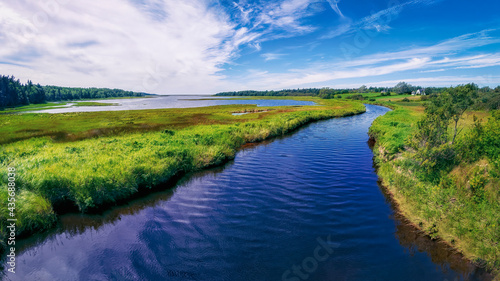 Fotografiet River and marshland on Cape Breton Island near the Atlantic Ocean in rural Nova Scotia, Canada on a bright sunny summer's day