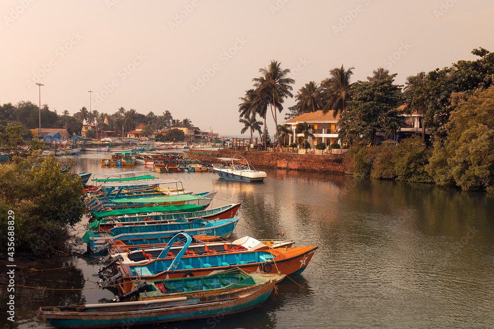 Fishing boats on an embankment of the river at sunrise