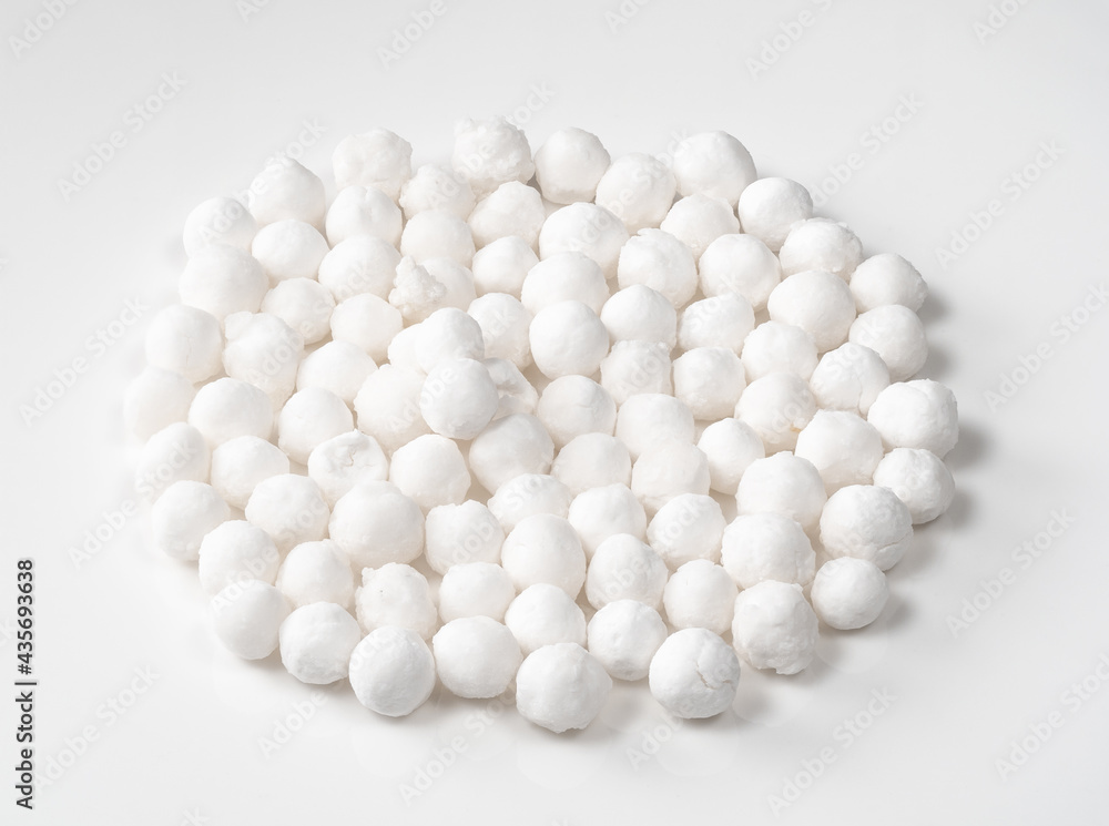 handful of raw tapioca pearls closeup on white