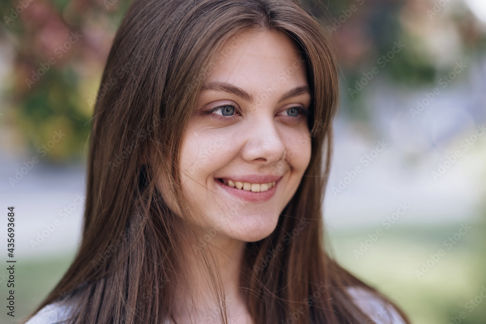 Close-up portrait of young woman face open eyes looking feel happy the day sun is shining and the wind blow. Face of beautiful soft woman with natural make-up. Close-up portrait of young woman face open eyes looking feel happy the day sun is shining and the wind blow. Face of beautiful soft woman with natural make-up.
