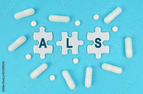 On a blue background, there are pills and puzzles with the inscription - ALS