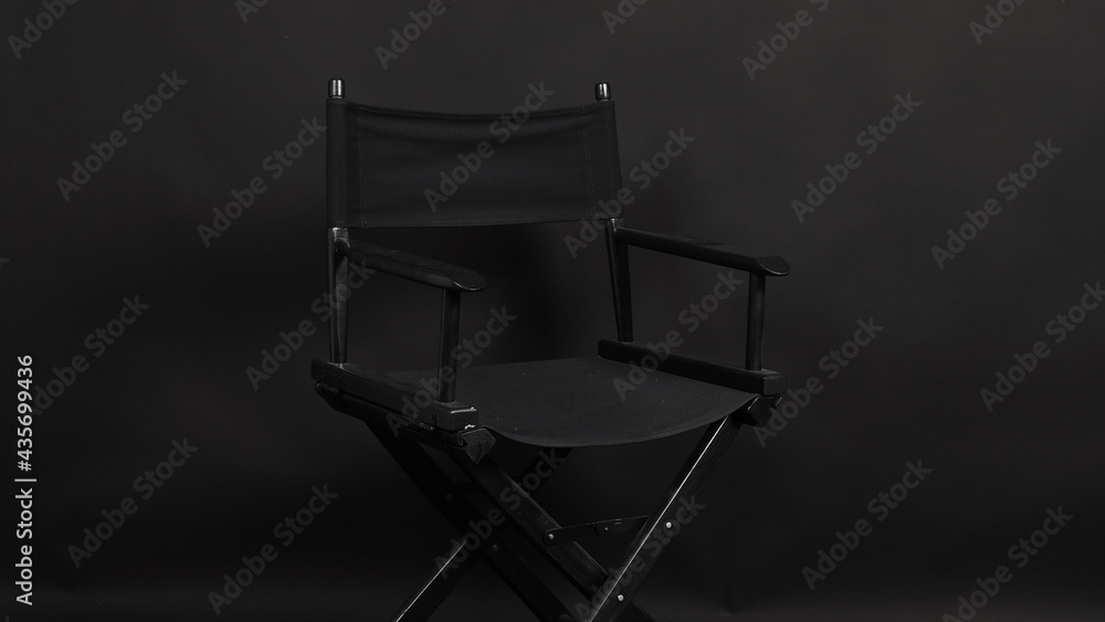 BLACK director chair isolated on black background. BLACK director chair isolated on black background.