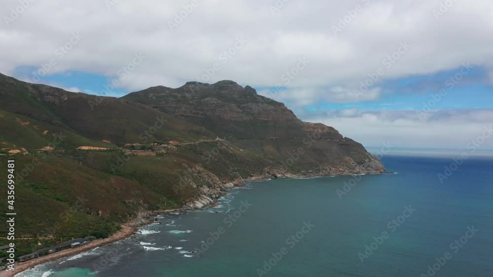 Aerial view. Chapmans Peak Drive near Cape Town, South Africa. Top view of road going through beautiful landscape. Road bending along the ocean. Aerial view. Chapmans Peak Drive near Cape Town, South Africa. Top view of road going through beautiful landscape. Road bending along the ocean.