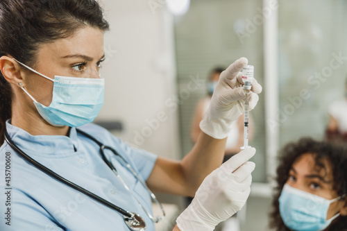 Nurse Holding Coronavirus Vaccine and Syringe